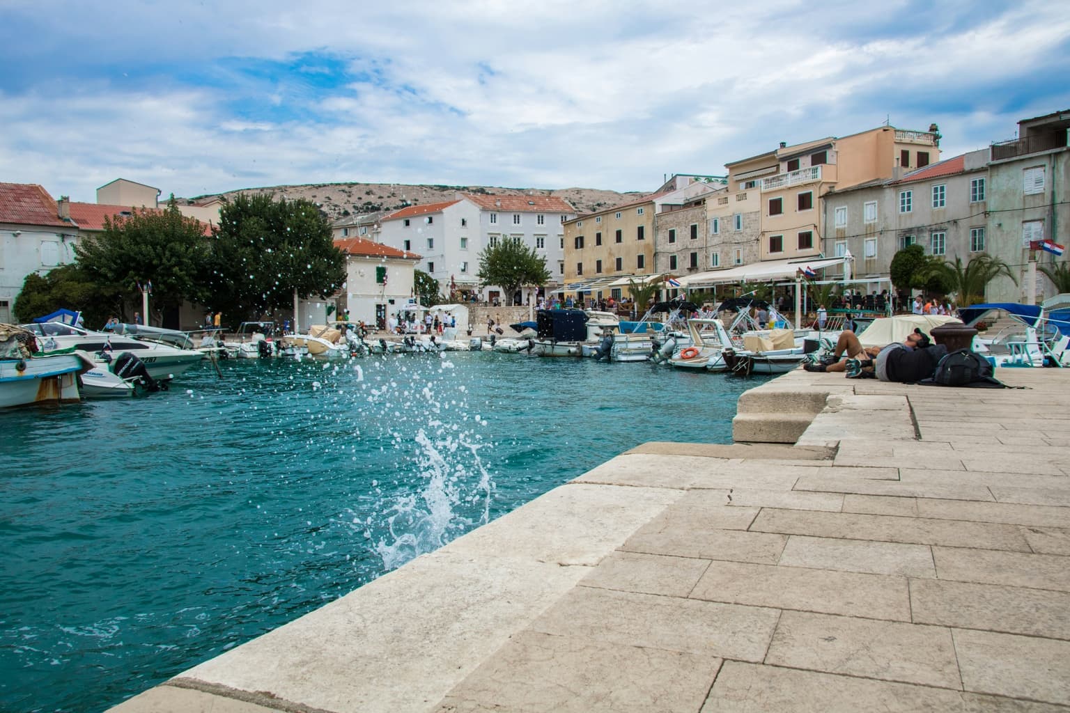 Pag harbour with boats and stone waterfront buildings